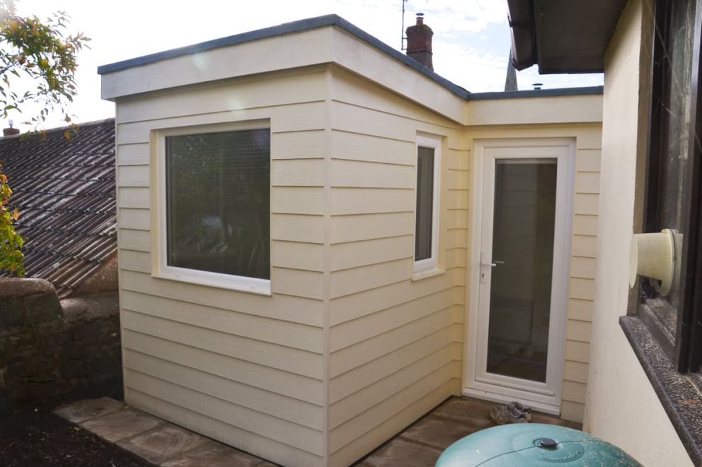 Cement particle cladding boards are used on this garden room