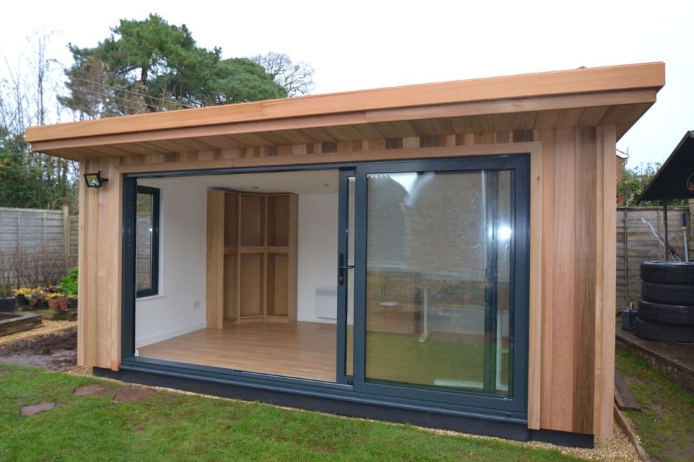 A spacious, light and airy garden office in Poltimore, Exeter. It features powder coated aluminium three leaf in-line sliding doors