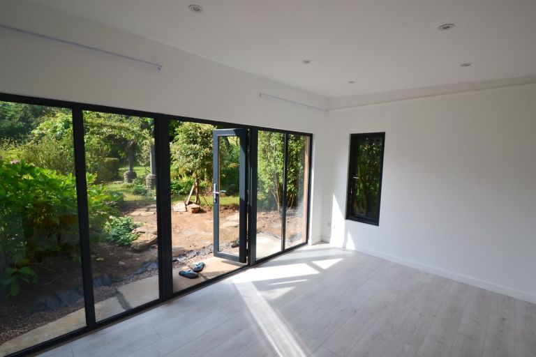 Inside the room features oak laminate flooring and recessed spotlights in the ceiling