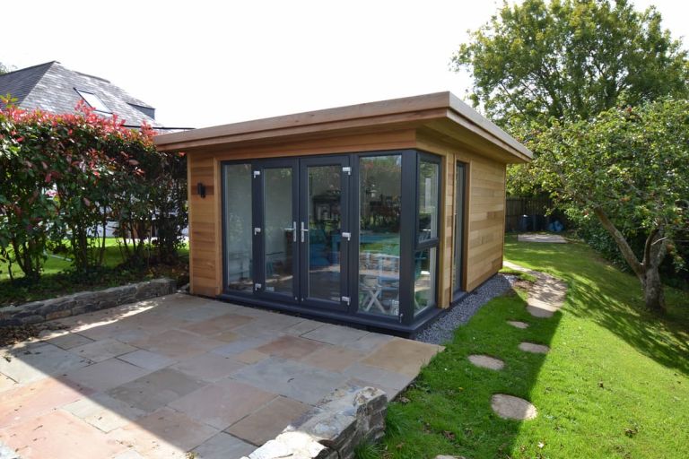 Front and side view showing the corner set glazing comprising of UPVC French doors, side lights and casement window