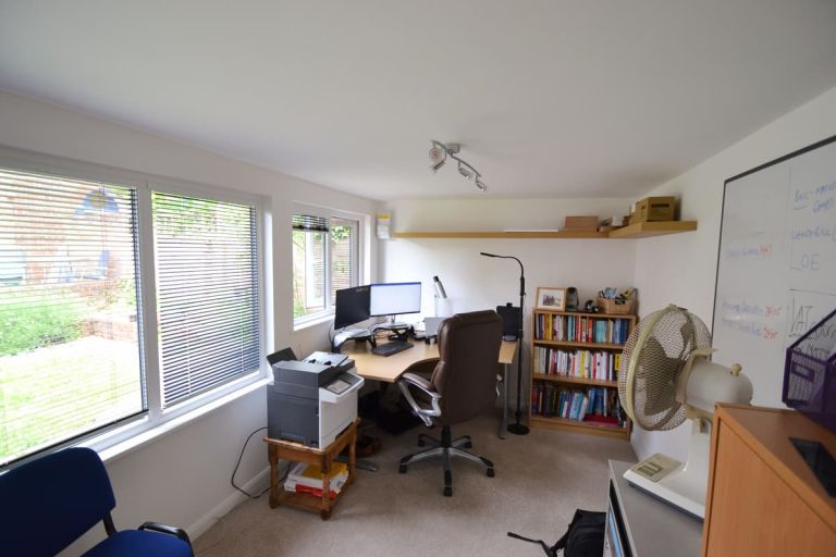 Interior of the building used as a home office. Light and area with desk overlooking the garden