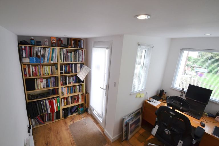 The bespoke garden room was designed around the dimensions of the furniture it needed to accommodate. Here, the shelves and desk space are shown