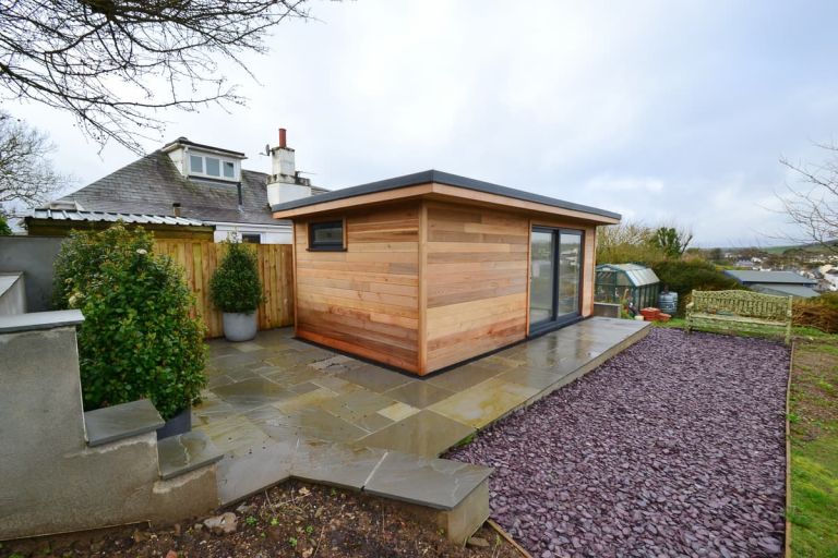 This 6m x 3m garden room has a sandstone patio area to the front and side