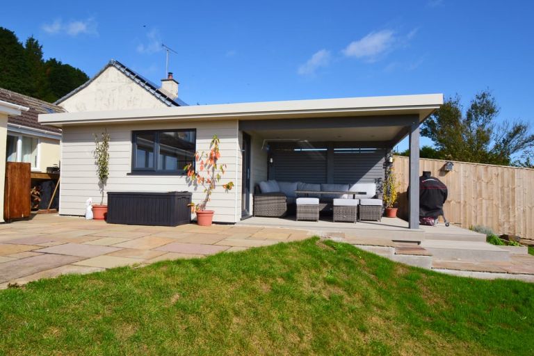 Millboard composite decking boards under the extended roof canopy