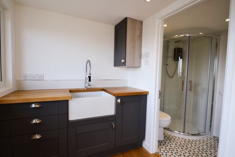 Kitchenette and shower room in a bespoke garden building by Inside Out Garden Rooms