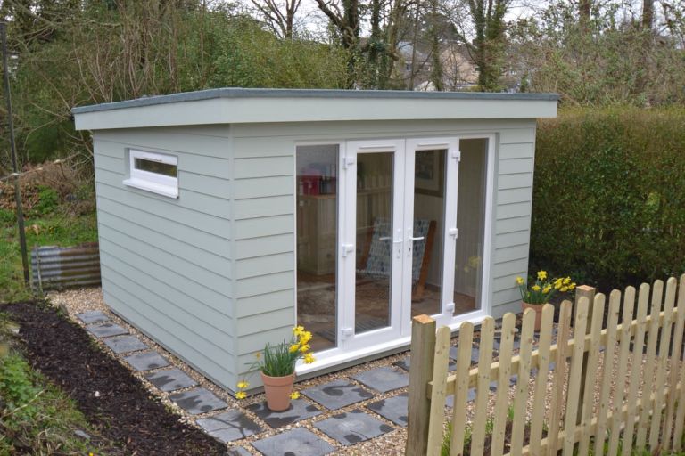 Exterior of a home office.  UPVC French doors with side lights and small ventilation windows