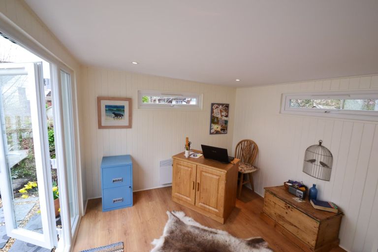 Interior of the bespoke home office. Showing decorated softwood TGV cladding on internal walls, plastered finish to ceiling