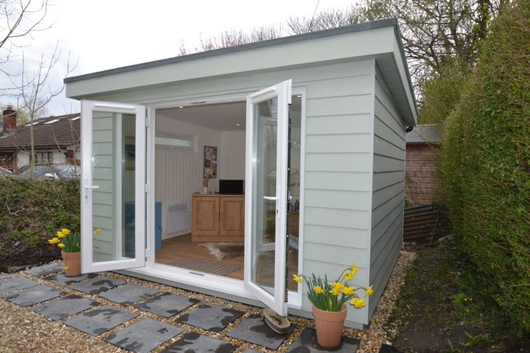 Home office with open UPC doors showing the hardwearing laminate floor inside