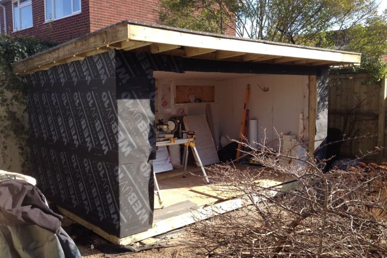 Garden room work in progress. The exterior walls are built and the insulation fitted