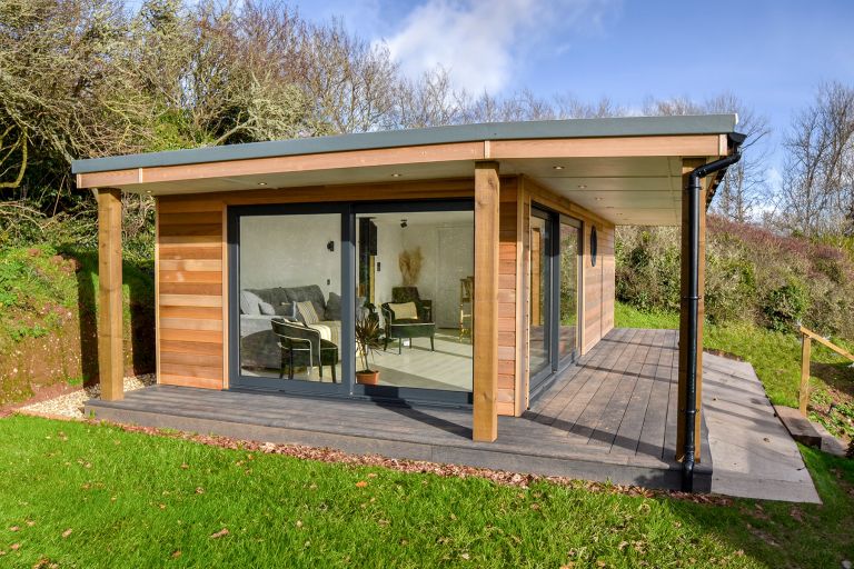 Exterior of the kiki-style garden room. View from the garden looking through the glazed elevation