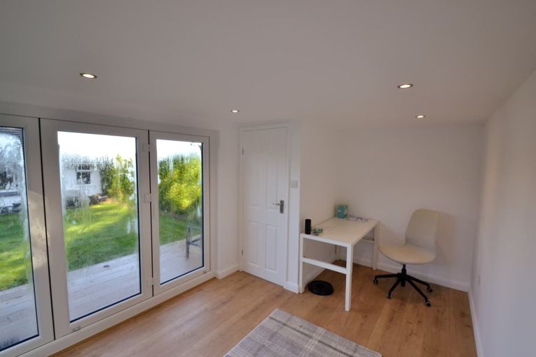 Internal stud partition wall with panel door leading to the toilet