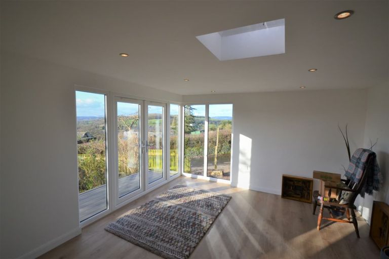 The walls of this garden room are plastered and decorated by Inside Out Garden Rooms. The company also fitted the heavy duty laminate flooring