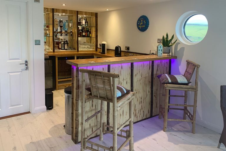 A garden room with a kiki-style bar. Bar stools and bar