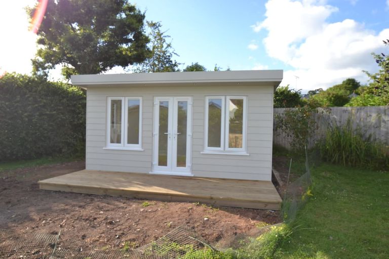 This garden room has a timber decking forward of the front elevation