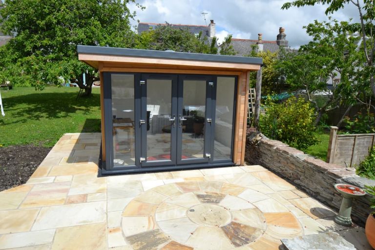 Writer's Retreat, shown from the front showing the double-glazed doors with windows either side